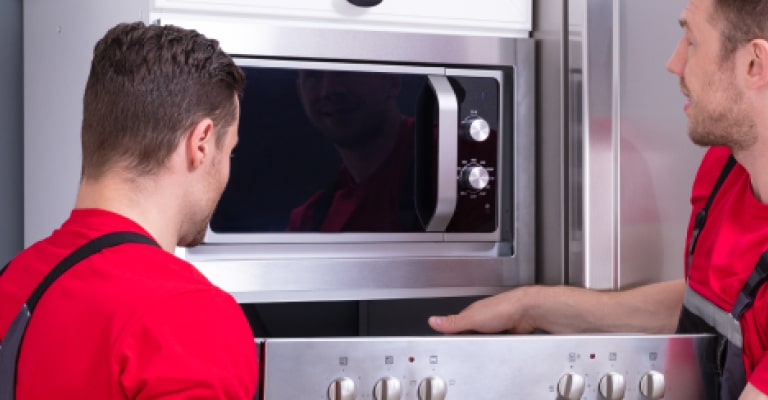 An engineer servicing a home appliance.