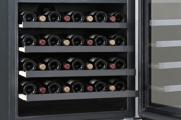 Bottles on four beech wood shelves inside the DeSantii 36 bottle wine cooler